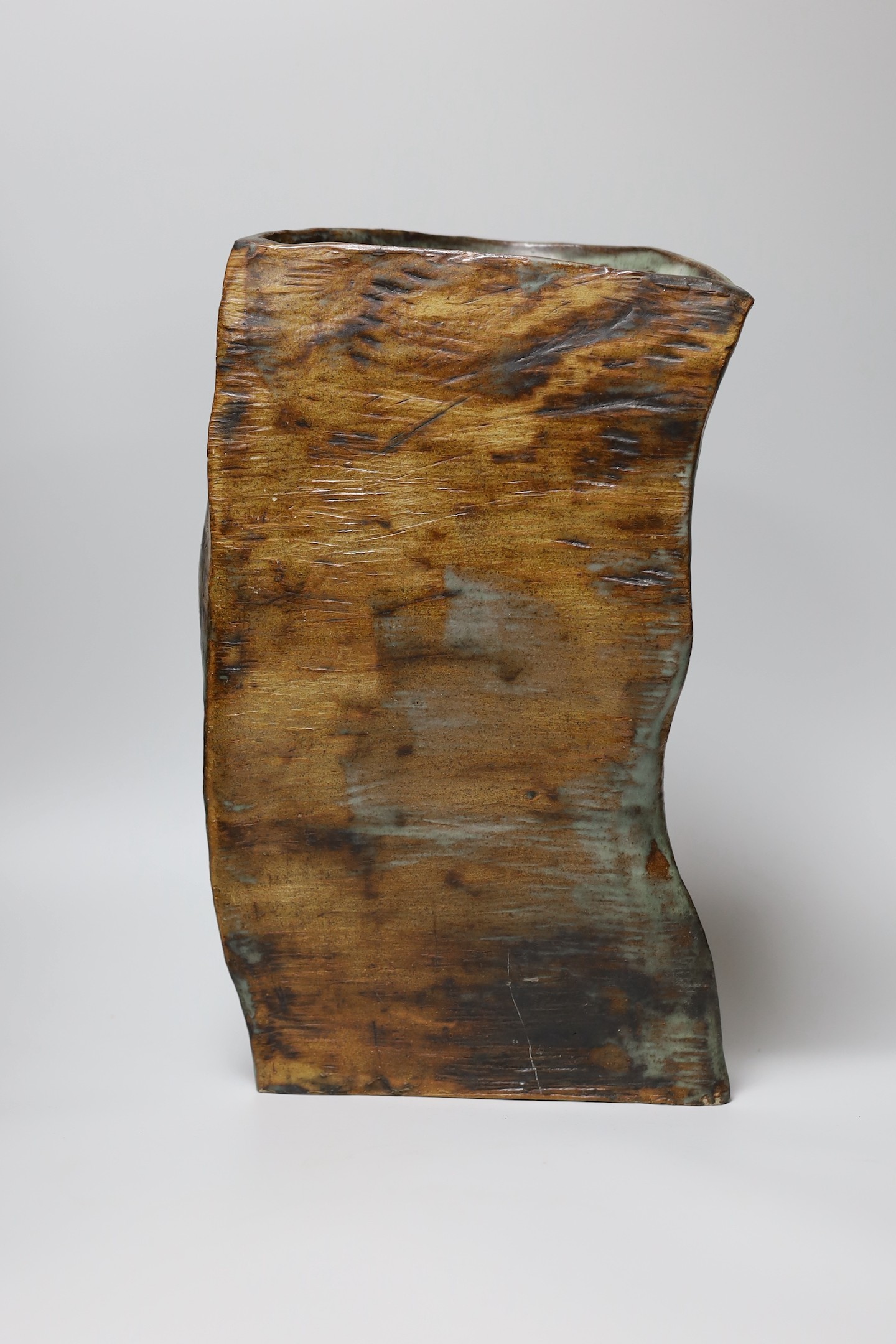 Ruth Sulke - a studio stoneware green and brown glazed free-form vase, 37cm